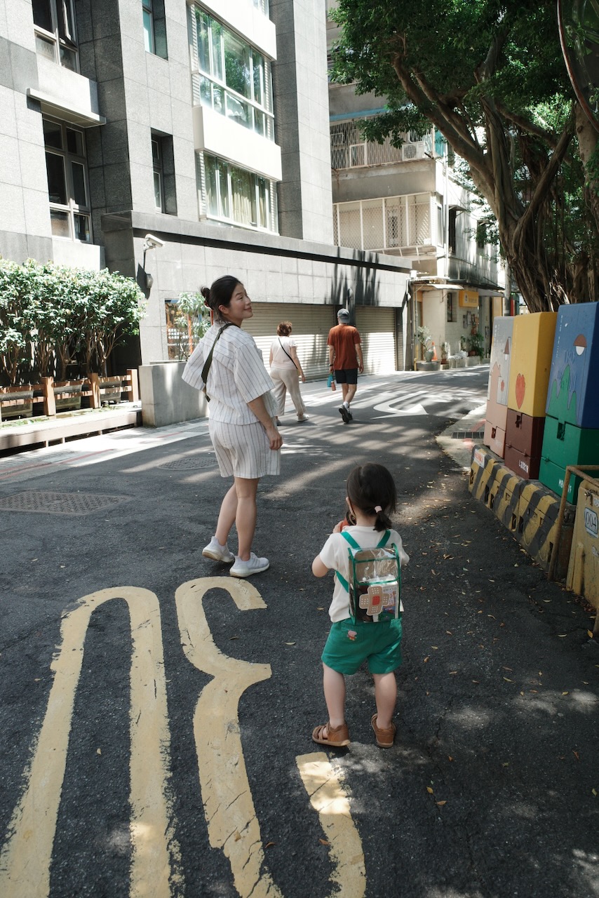A family walking through the streets of central Taipei, Taiwan.
