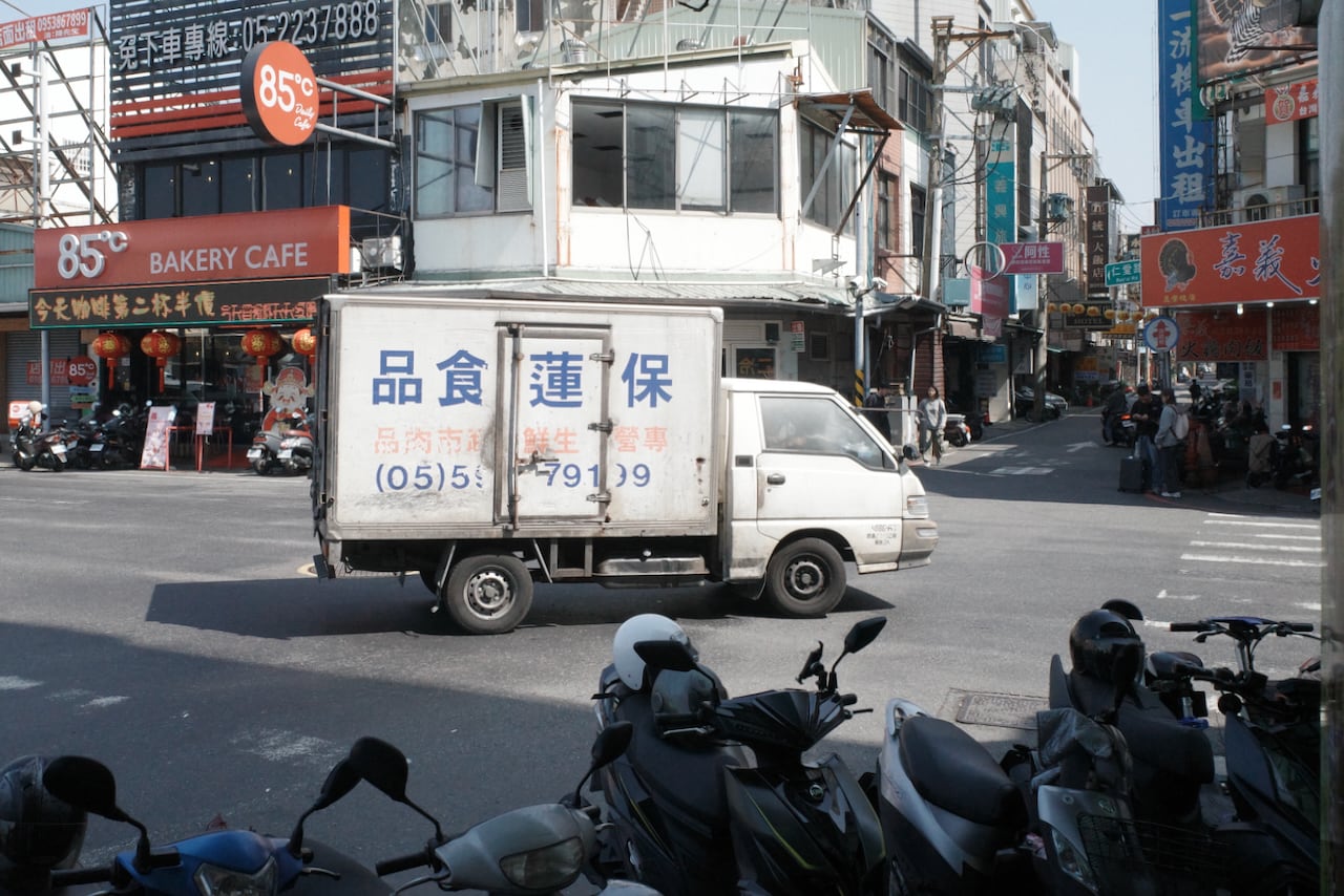 An older white refrigerated cab version on the streets of Jiayi