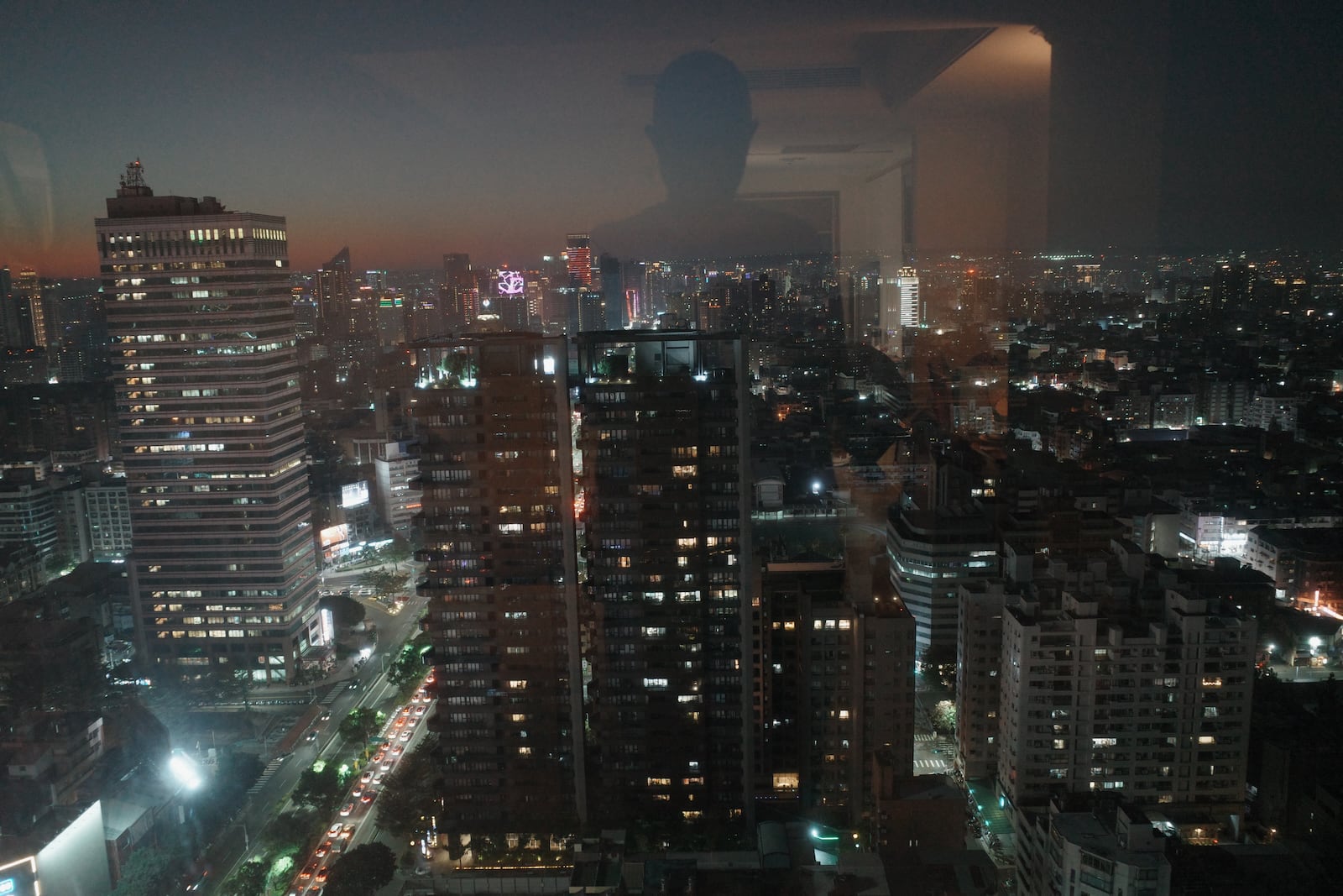A night-time view of a modern district of Taichung from a high floor